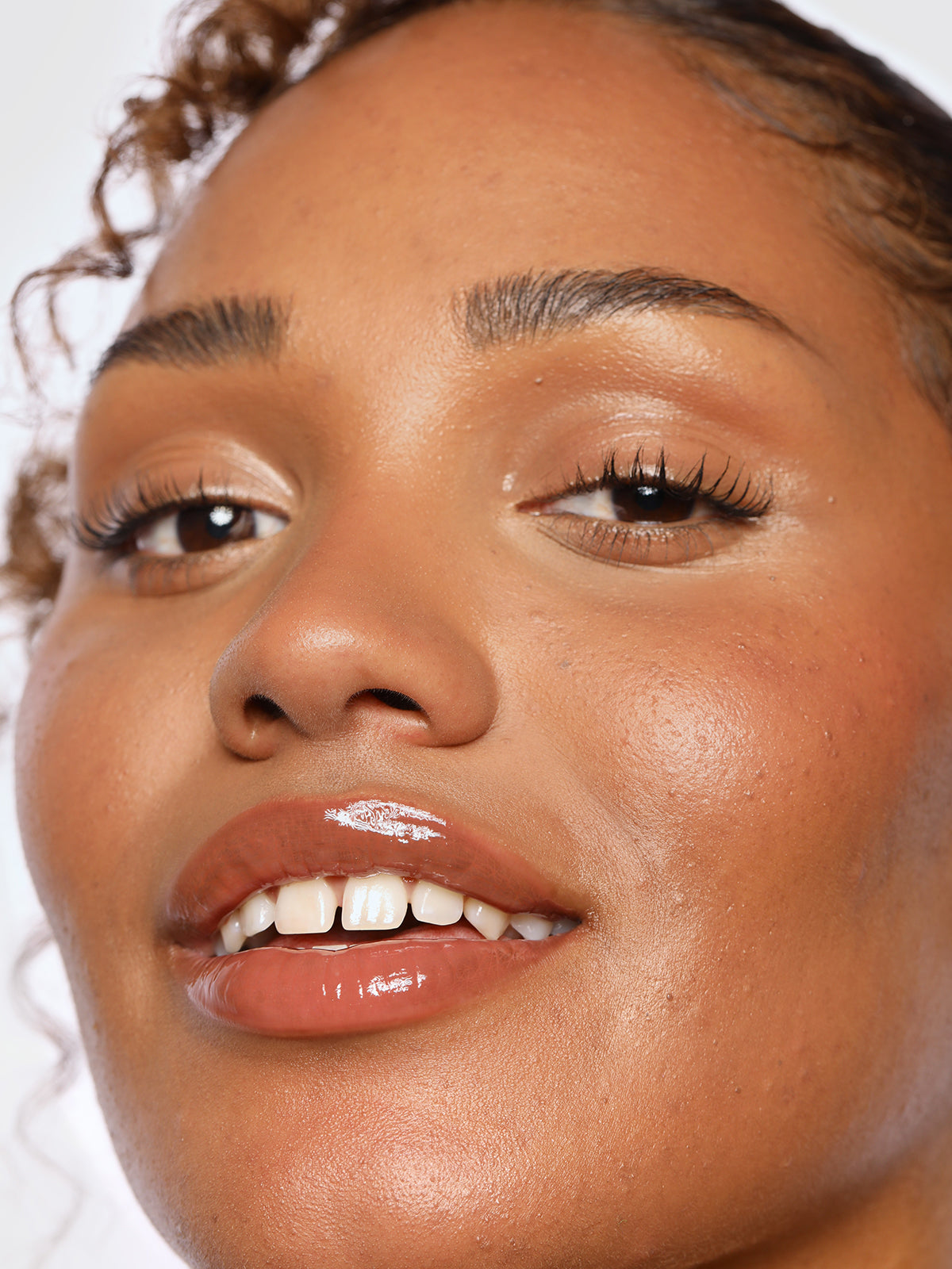 REFY TINTED LIP GLOSS IN SHADE FAWN ON MODEL