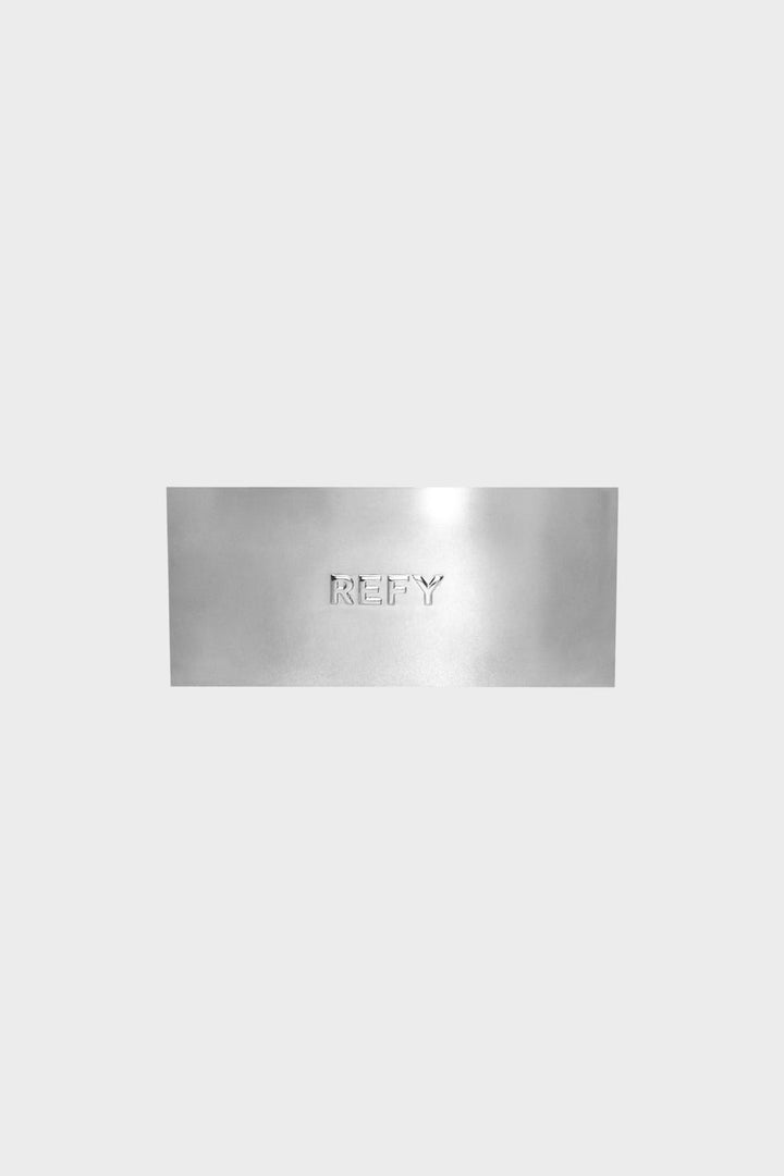 CLOSE UP OF REFY METAL RECTANGLE HAIR CLIP WITH EMBOSSED LOGO