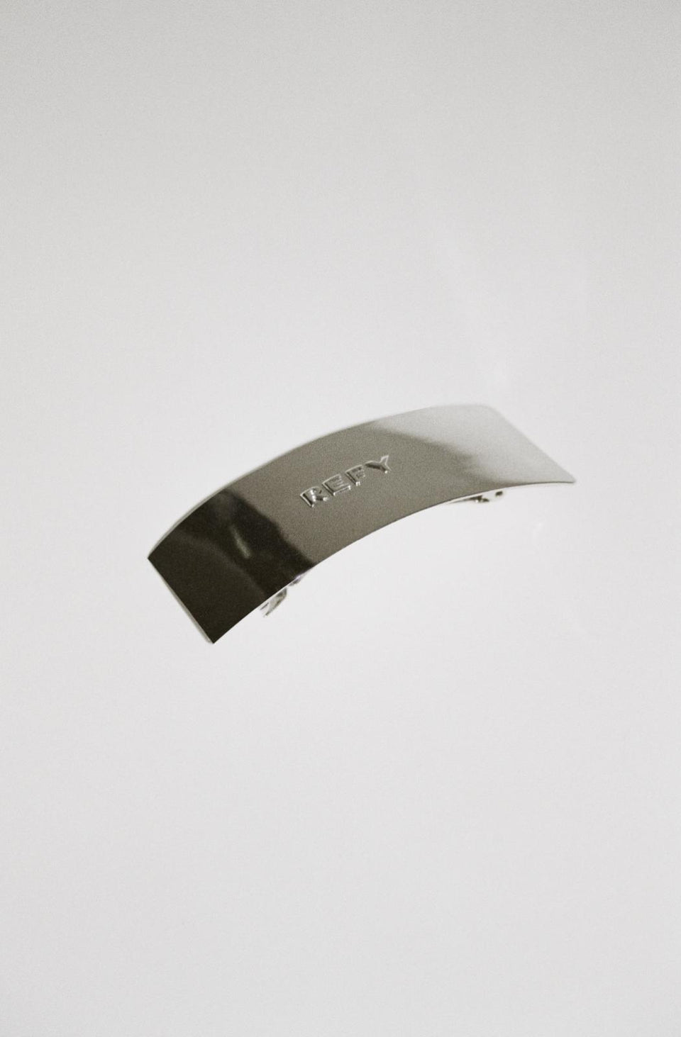 FRONT IMAGE OF REFY METAL RECTANGLE HAIR CLIP WITH EMBOSSED LOGO